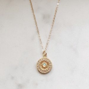 Gold necklace with opal stone.